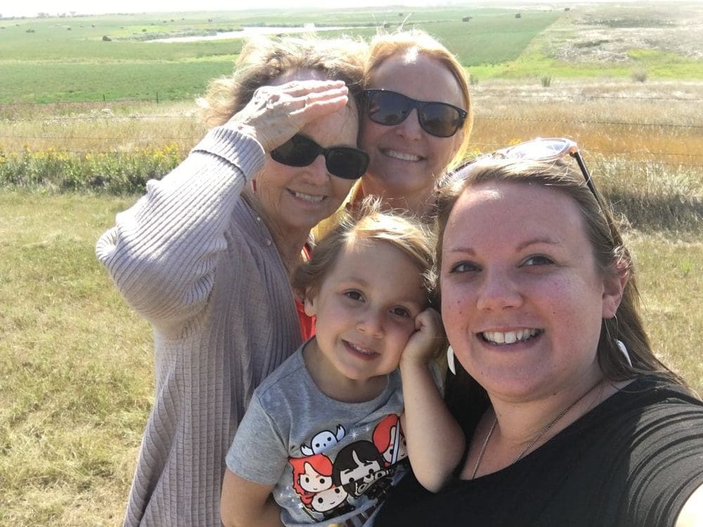 Four generations of women take a selfie in a North Dakota field.