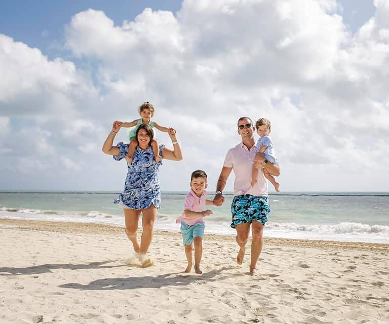 Family walking on the beach at the Moon Palace hotel