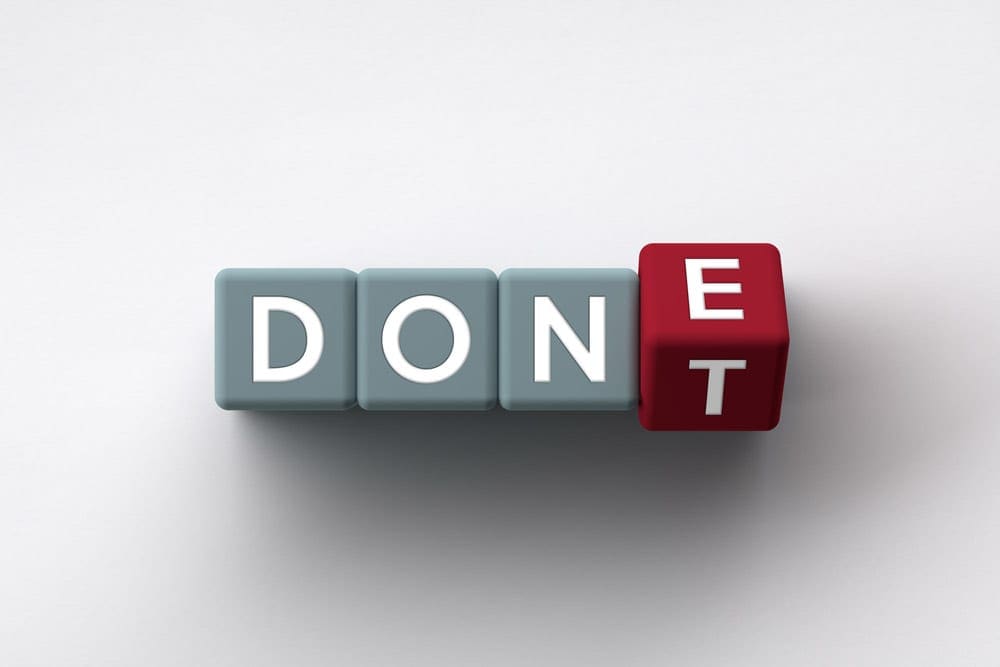 Three gray letter blocks, followed by one red lette block spell out the word "DONE". The red letter block is changing from "E" to "T", converting the word from "DONE" to "DON'T".