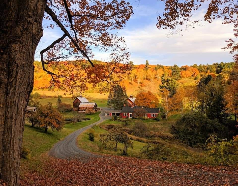 A lovely farm sits within a valley in Sleepy Hallow Vermont on an exquisite fall day awash in autumn hues.