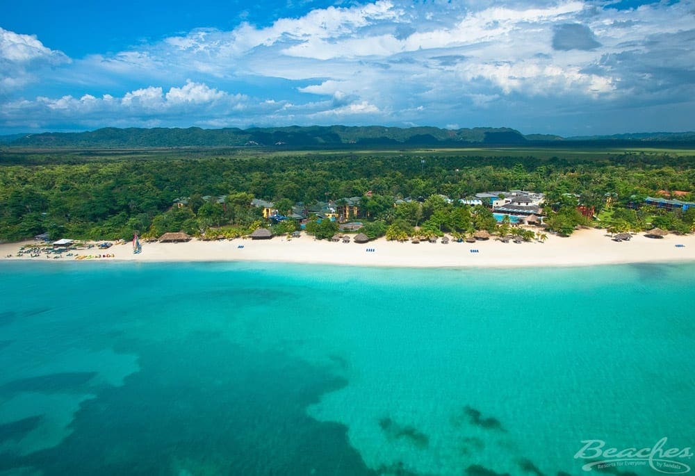 An arial view of the ocean, beach-line, and grounds at Beaches Negril, one of the best all-inclusive resorts in the Caribbean for families.