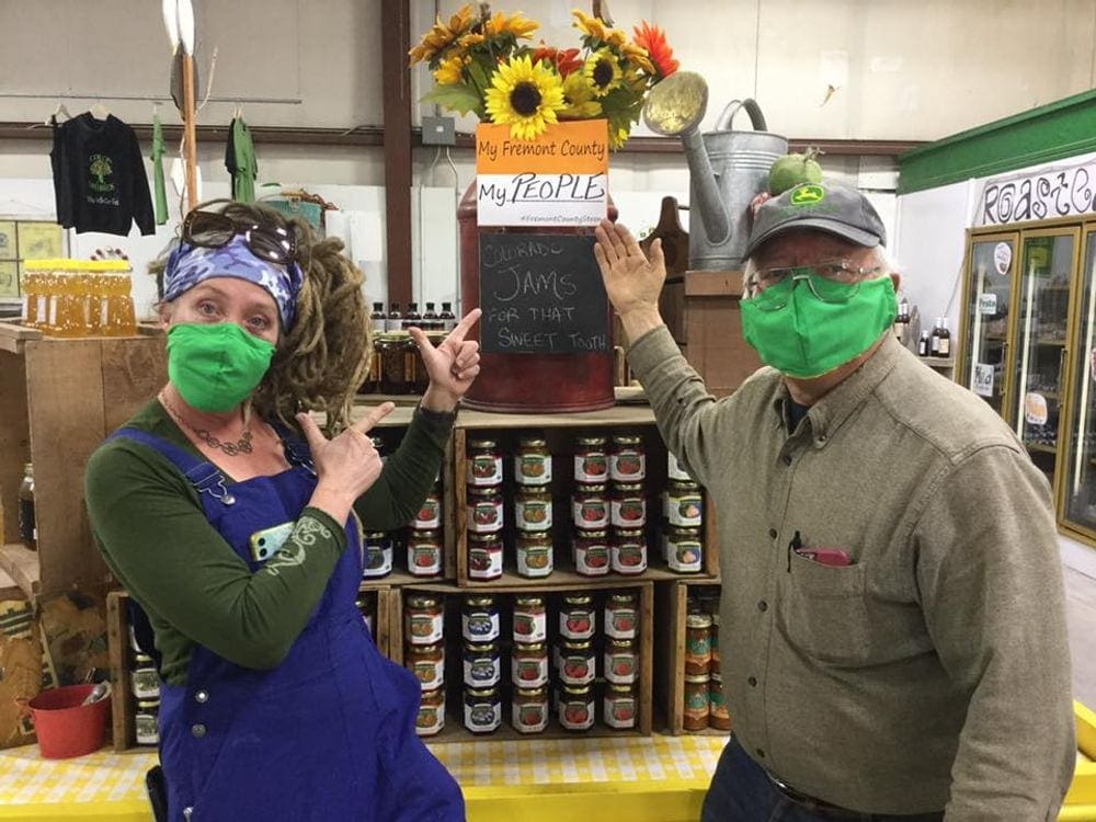 Father and daughter point to a jam display at Colon Orchards, one of the best fall activities in Colorado with kids.