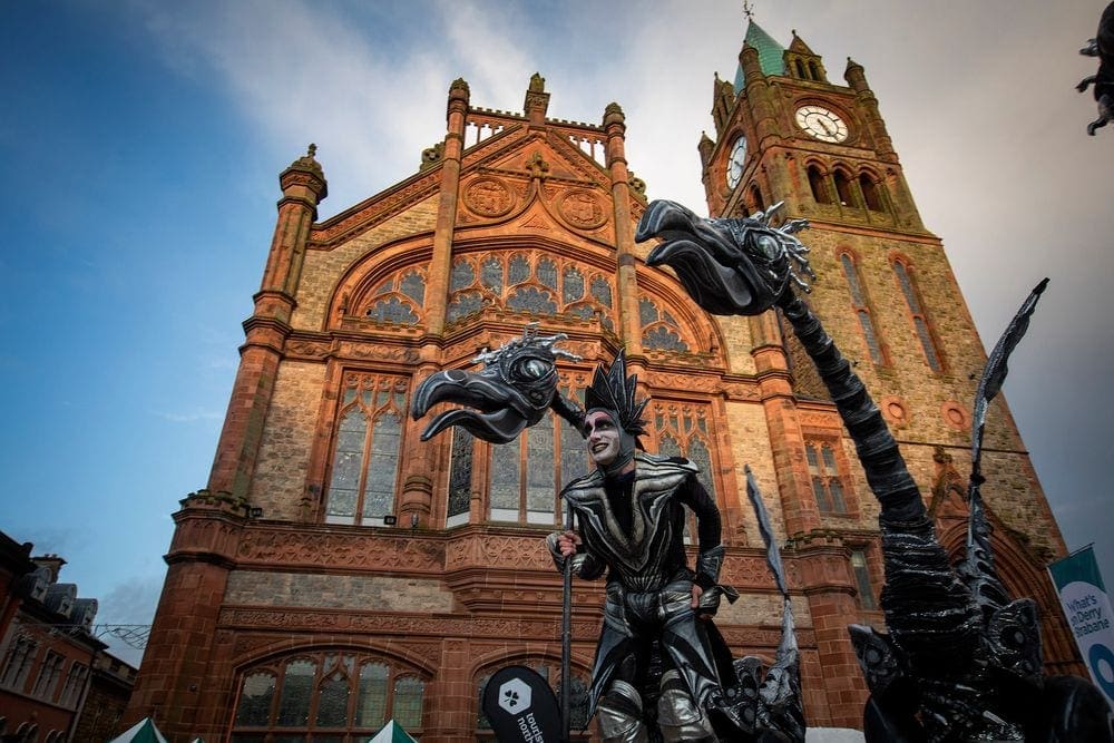 A large puppet of a two-headed dragon is steered down the streets of Derry, Northern Ireland, one of the best places to go for Halloween, during a parade.