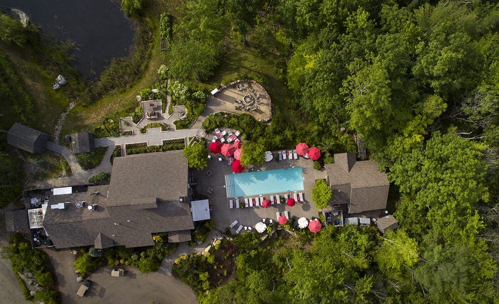 An aerial view of the Hidden Pond grounds, including the main building and pool.