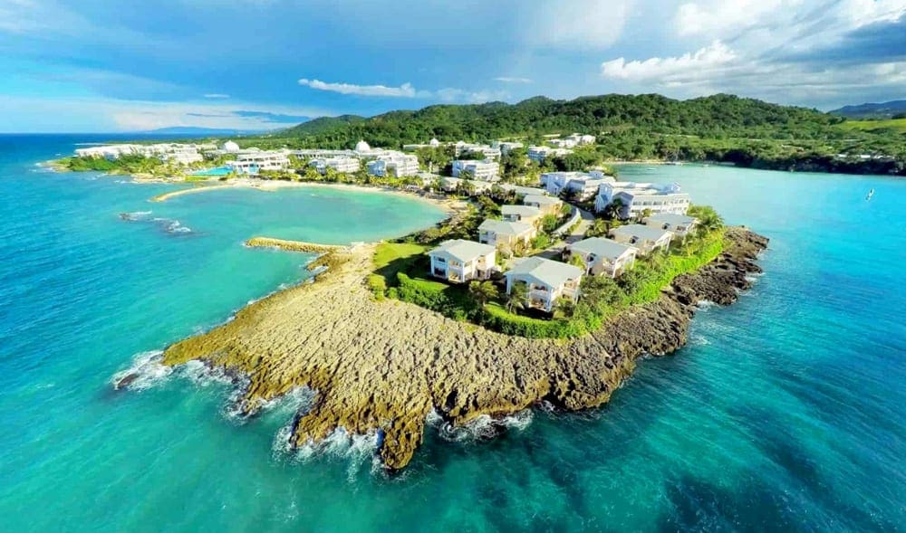 An aerial view of The Grand Palladium Jamaica Resort, surrounded by crytal blue waters, one of the best Caribbean resorts with baby clubs..