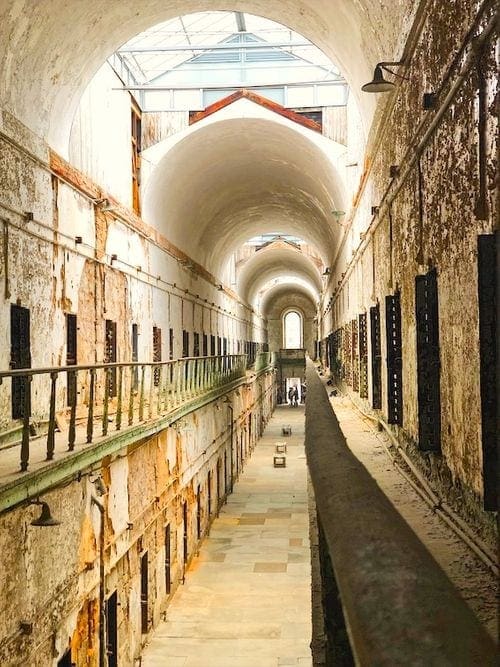Inside the Terror Behind the Walls Easter State Penitentiary in Philadelphia, featuring a long hallway with several cellblocks.