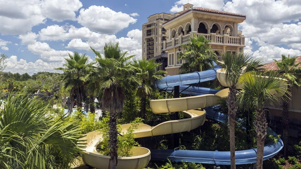 A view of the Four Seasons, Orlando, featuring two large outdoor water slides on the property. This is one of the best luxury hotels in the U.S for families!