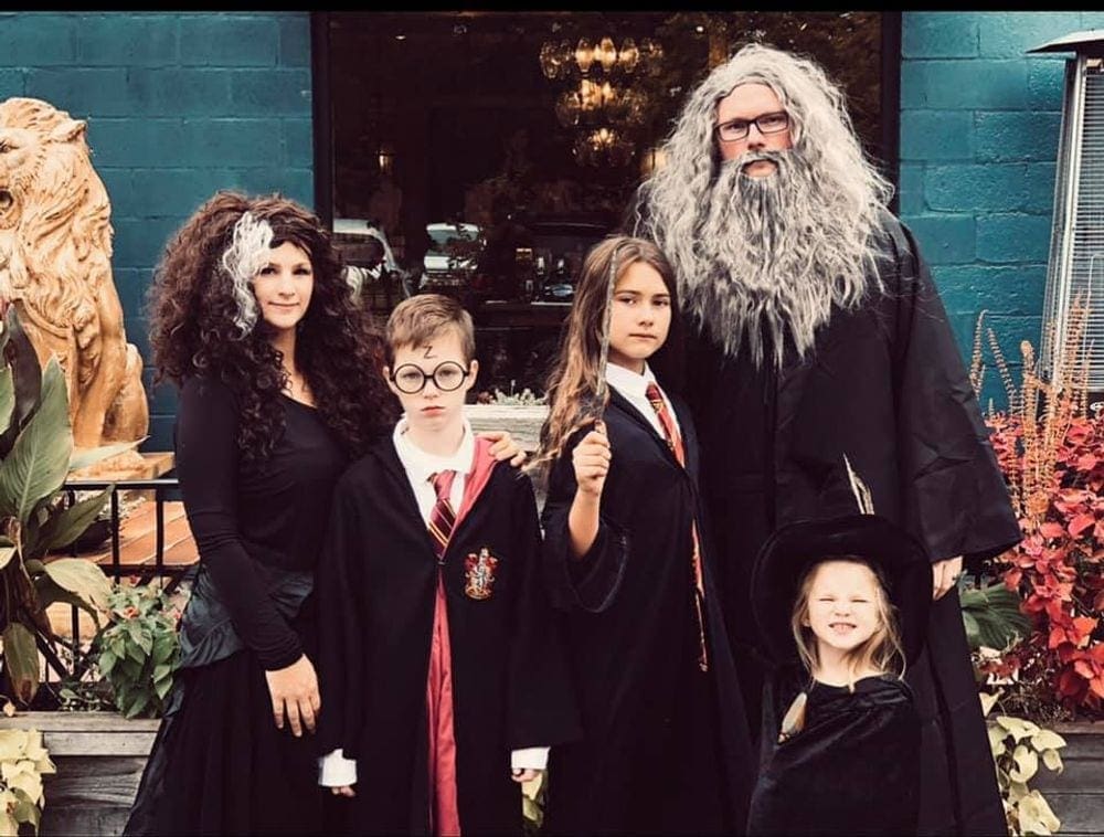 A family of five is dressed in Harry Potter-inspired costumes for Halloween.