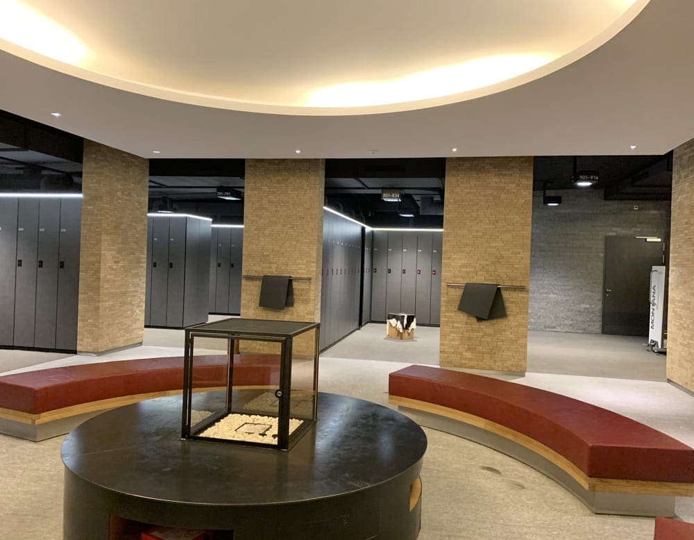 The Suvretta House locker rooms, featuring a fire place and red benches.