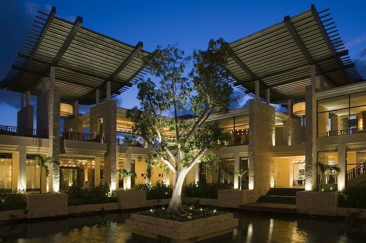 A view of the elaborate entrance to Banyan Tree Mayakoba, one of the best resorts in Playa del Carmen, at night.