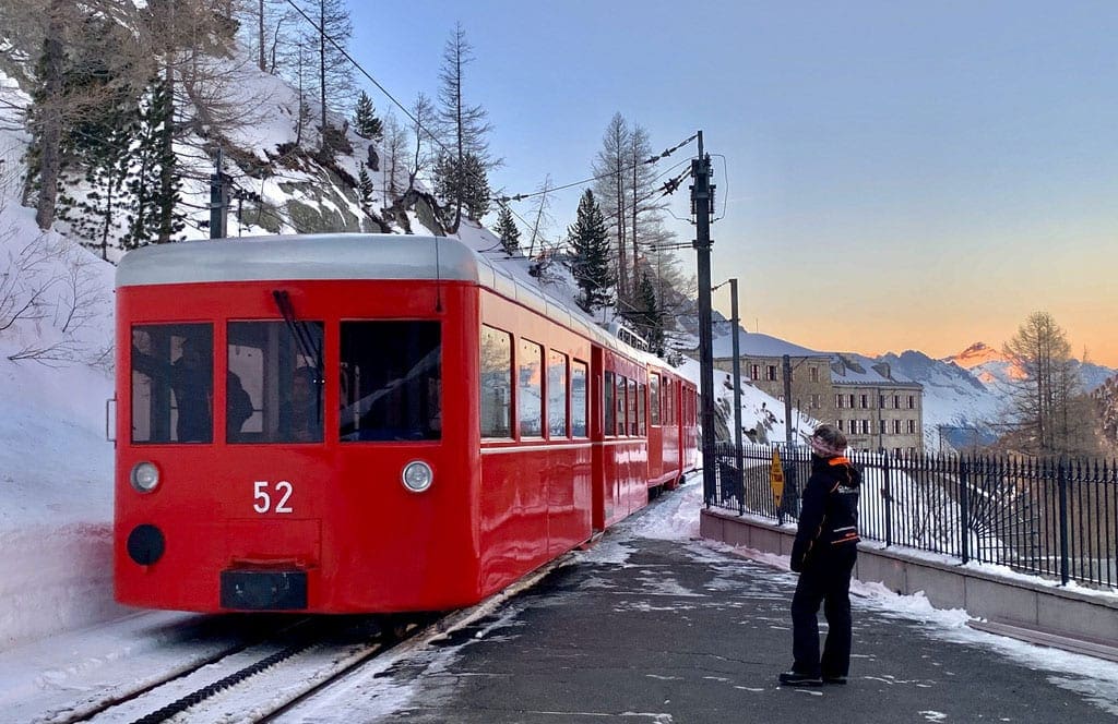 A man looks on at the inconic Mer de Glace red train in Chamonix, one of the things to do in Chamonix with kids.