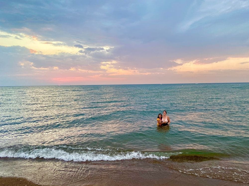 A young girl and her mom swim in Michigan.