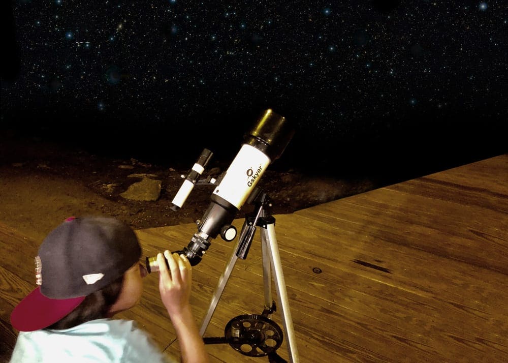 Boy looking at the stars with the telescope