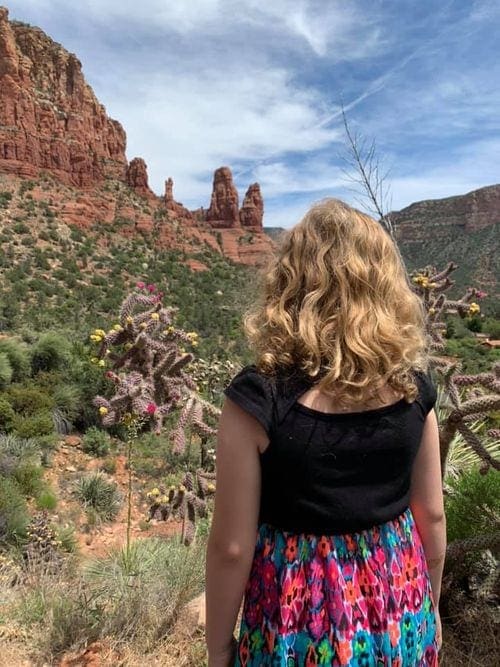 A young girl looks at the red rocks in Sedona.