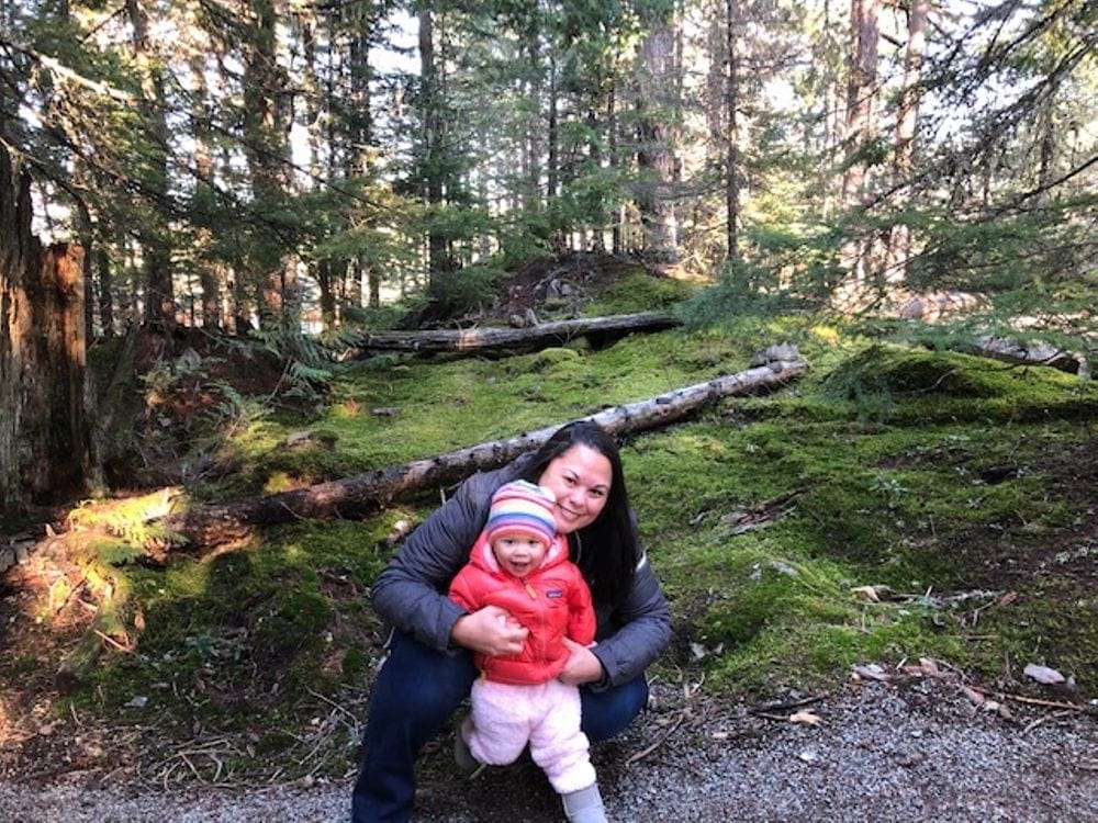A mom and her infant daughter enjoy a hike near Whistler.