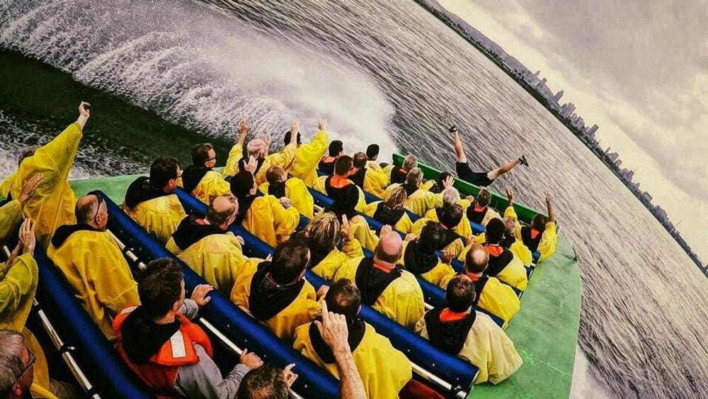 A boat carrying dozens of passangers on a river in Montreal, as part of the Saute-Moutons Jet Boating tours.