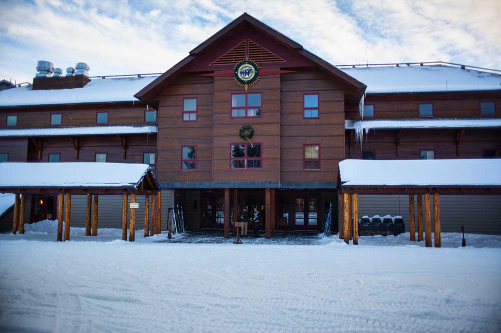 Old Faithful Lodge in Yellowstone National Park covered in snow