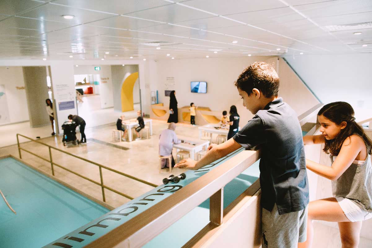 Two kids play at an interactive exhibit at OliOli Experimental Centre.