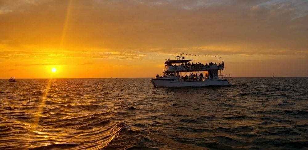 A double deck cruise ship carriers passangers on a sunset cruise in Naples, Florida.