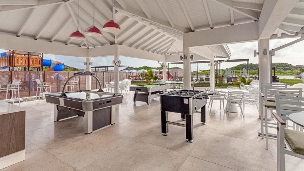 Inside the Teen Club at the Royalton Antigua Resorts & Spa, featuring several large game tables.