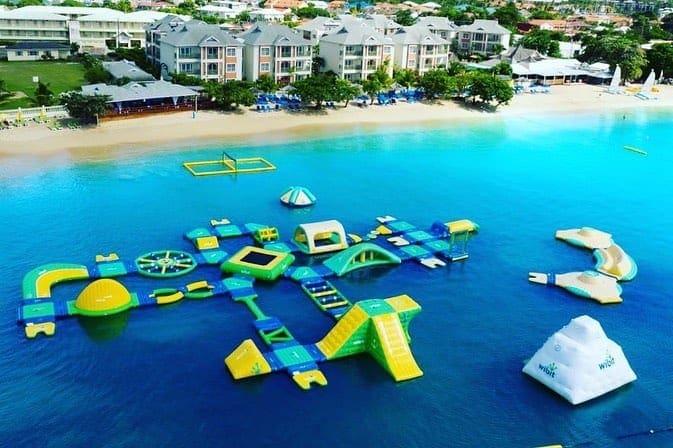 An aerial view of the Splash Island Water Park. featuring green, yellow, and blue equipment.