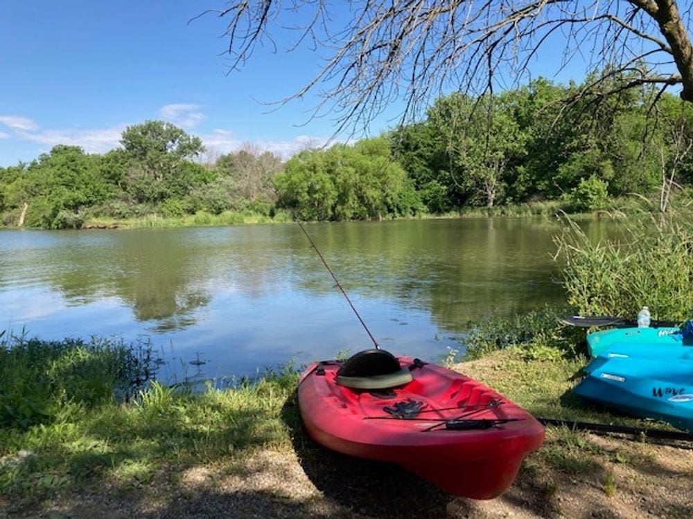 A red kayak rests along the shore of Lake Evergreen, one of the best places in Northern Illinois for families