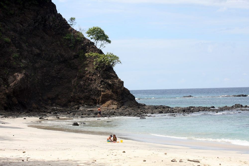 Two kids playing on the beach near Four Seasons Resort Costa Rica at Peninsula Papagayo.