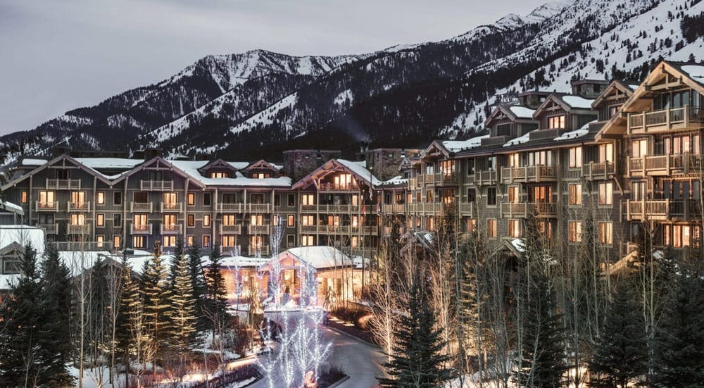 The resort building lit up on a winter day at Four Seasons Resort & Residences Jackson Hole, one of the best ski-in/ski-out resorts in the U.S. for families.