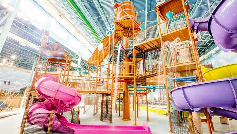 A number of water slides in a brightly lit pool area at the Great Wolf Lodge near Phoenix.