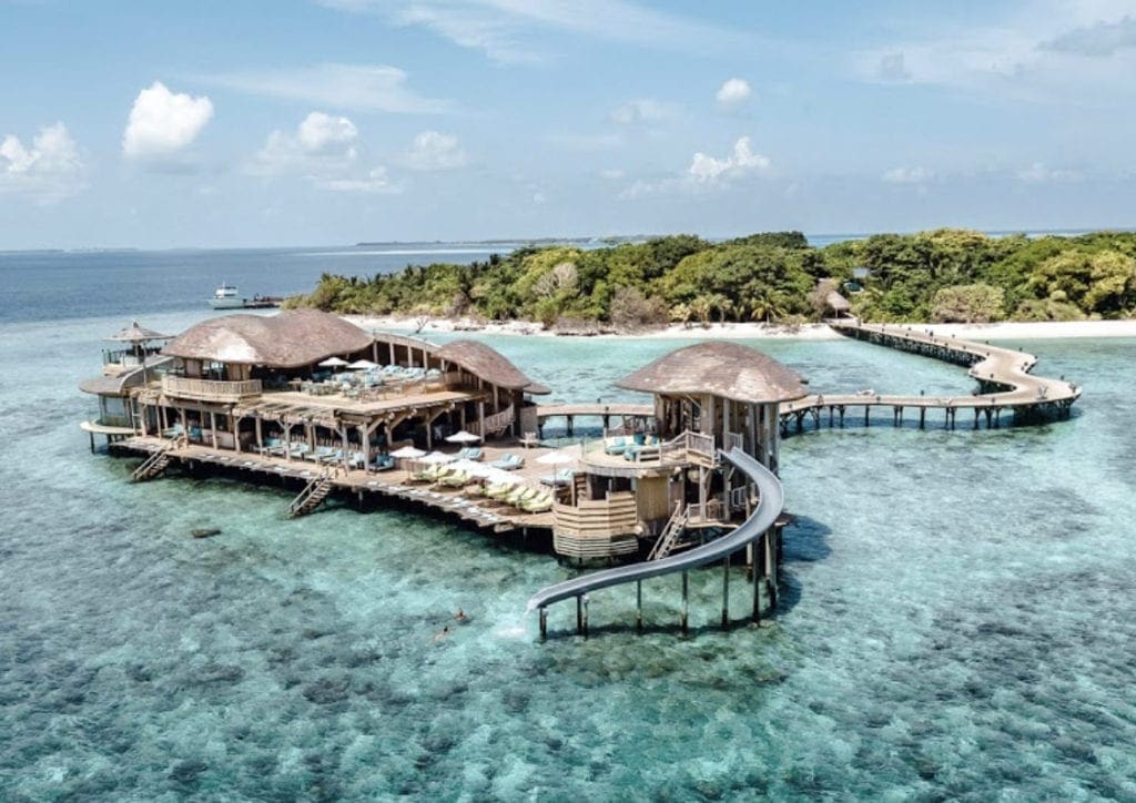 The main building at Soneva Jani, with a slide extending into the ocean.