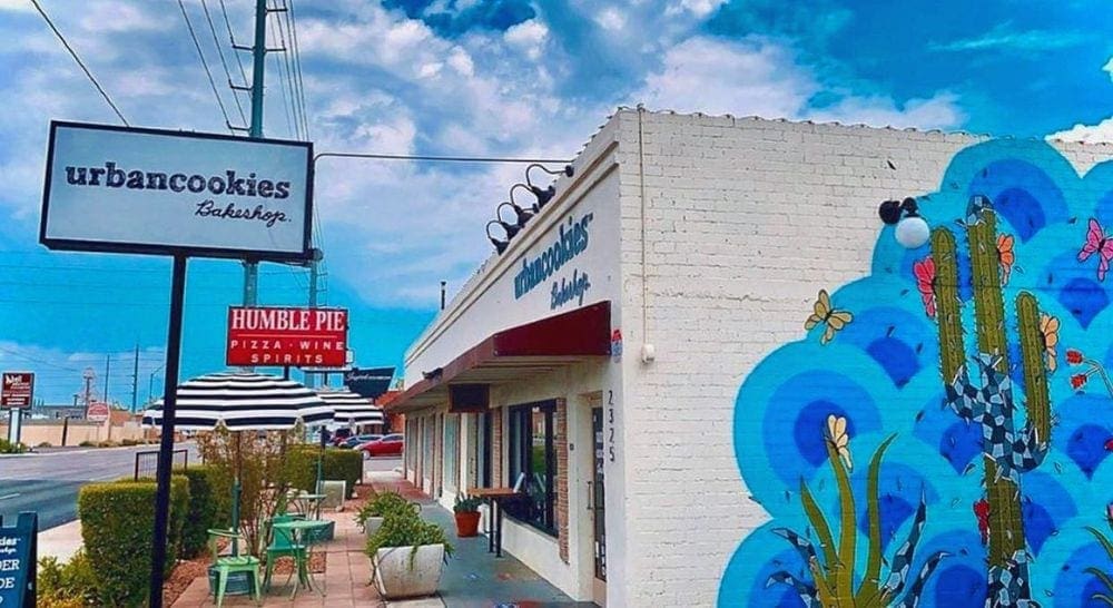 The vibrantly colored Urban Cookies Bakeshop and sign on a brilliantly sunny day.