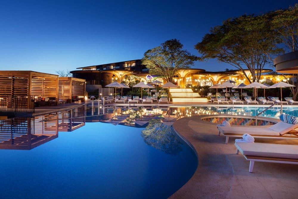 The pool and hotel grounds at night at W Hotel Reserva Conchal, one of the best Costa Rica resorts for a family vacation.