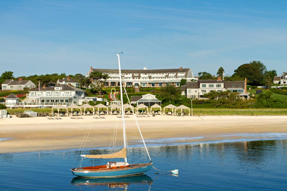 The rear exterior to Chatham Bars Inn, featuring a pristine beach and immediate access to ocean waves.