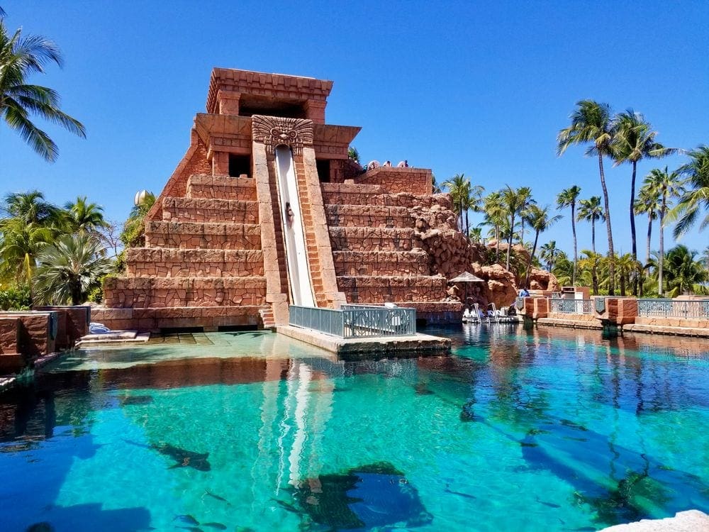 A large slide stretches into a pool at Atlantis Bahamas.