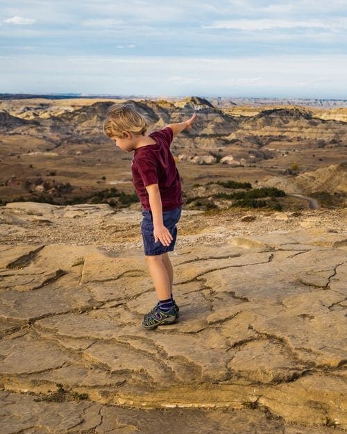 A young boy hikes along a trail near Medora, North Dakota.