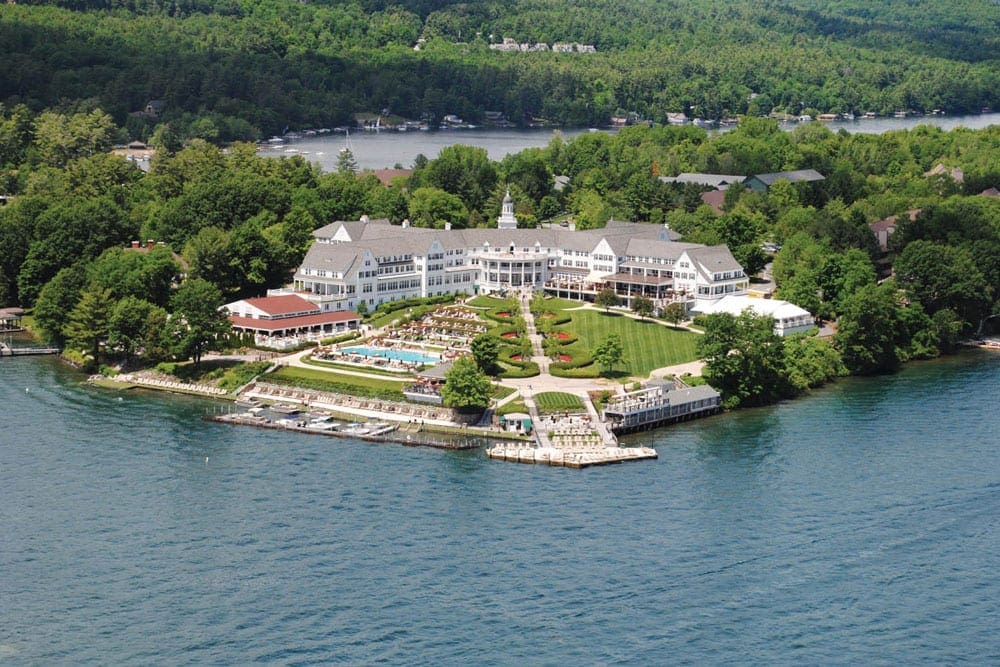 An aerial view of The Sagamore Resort, one of the best summer lake resorts in the Northeast for families, nestled along the lakeshore.