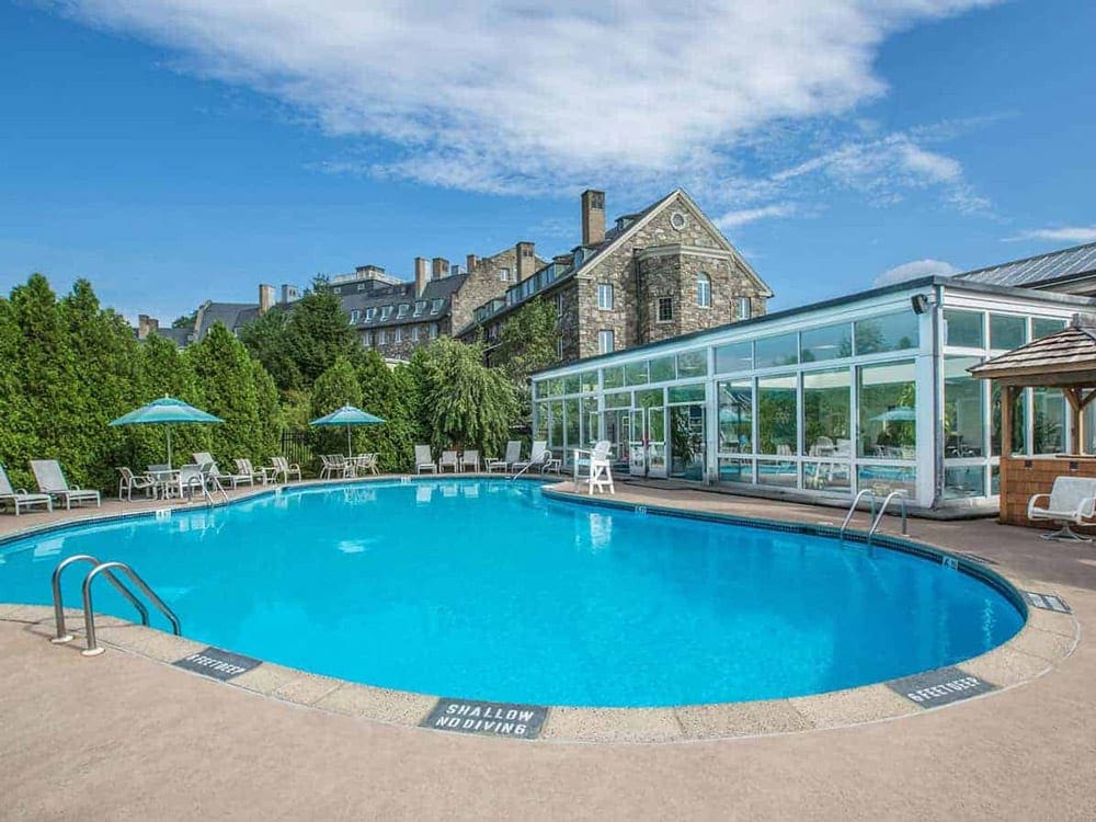 A large pool sits in front of resort buildings at Skytop Lodge.