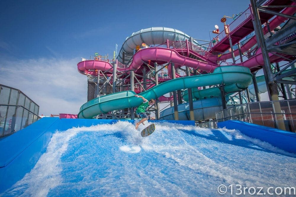 A young boy uses a boogie board on the water at the Splash Zone Waterpark.