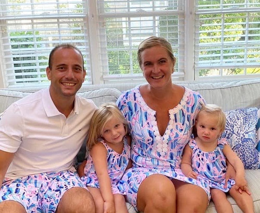 A family of four wearing matching Lilly Pulitzer smiles inside the Lilly Pulitzer Cottage on at family vacation to Nantucket.