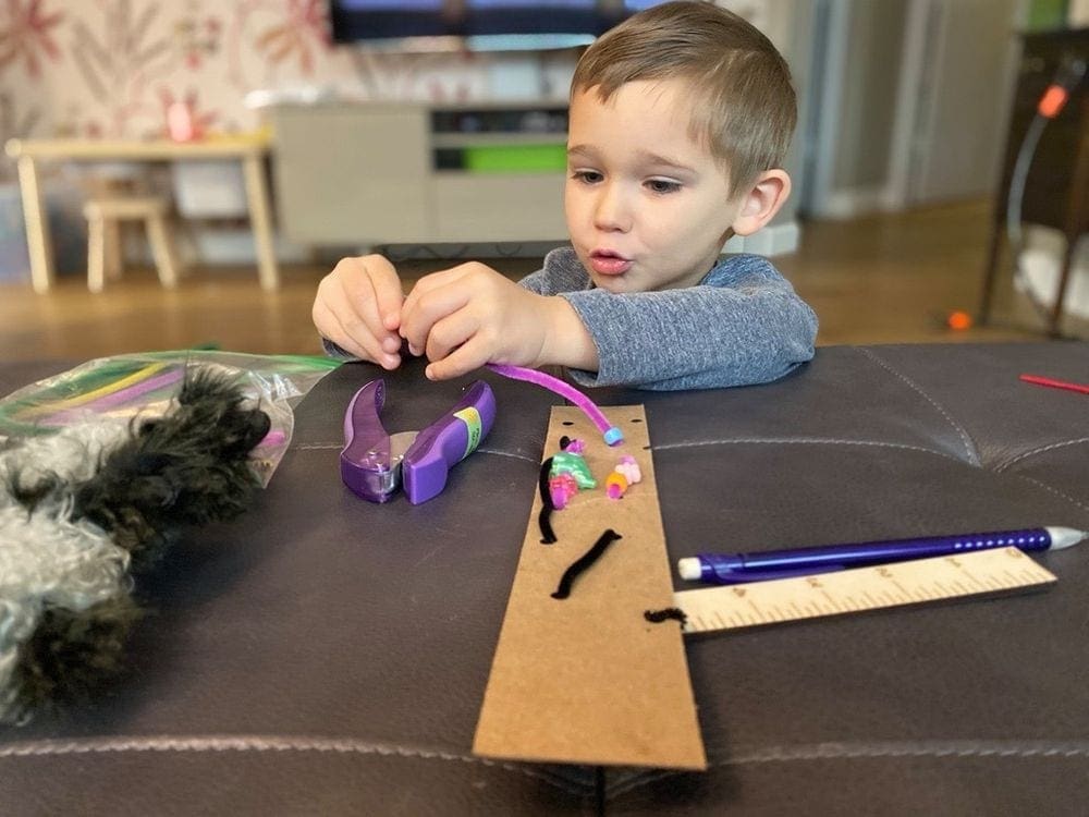 A young boy works on a craft at the Tinkery, one of the best things to do in Austin with kids.