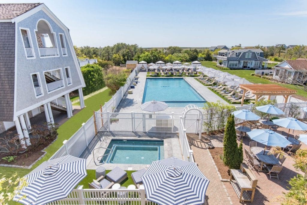 An aerial view of the large pool and jacuzzi at the Winnetu Oceanside Resort.