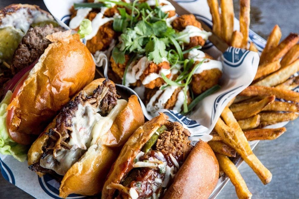 A basket filled wiht iconic Juicy Lucys and frenchfries from the Blue Door Pub in St. Paul, Minnesota.