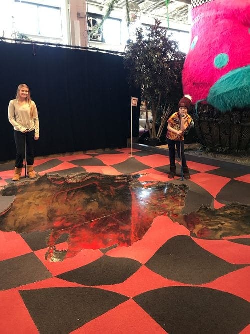 Two kids play mini golf at Can Can Wonderland in St. Paul, Minnesota.