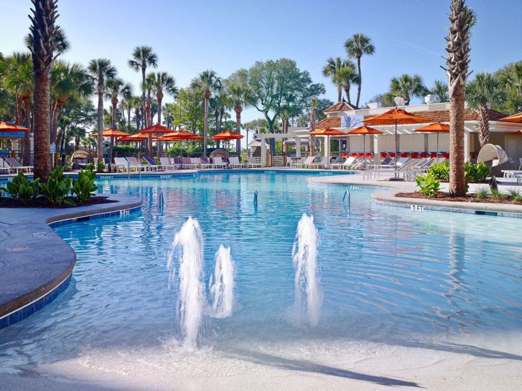 A view of the huge, kid-friendly pool and pool deck at Sonesta Resort Hilton Head Island, one of the best family hotels in Hilton Head.