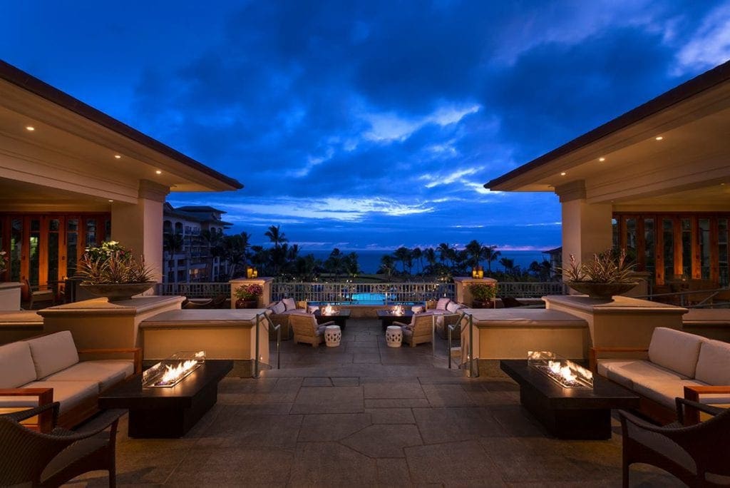 A lit patio area, featuring inviting fire pits at The Ritz-Carlton, Kapalua, one of the best family hotels in Maui.
