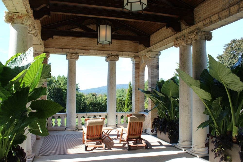 Two empty chairs rest on the terrace with a stunning view of the grounds of the Wheatleigh.