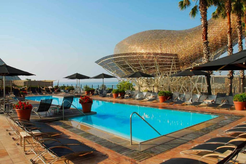 The rooftop pool at Hotel Arts, one of the best family Barcelona hotels, on a sunny day.