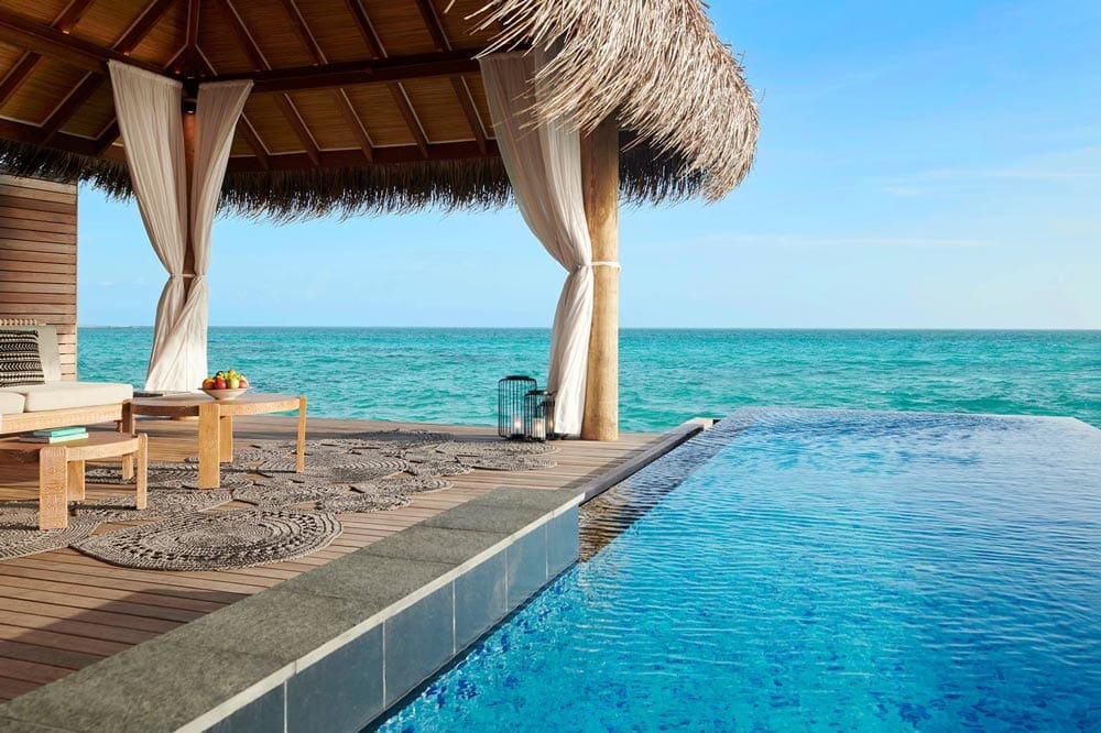 A close up view of a covered patio area near the ocean at the Hotel Fairmont Maldives - Sirru Fen Fushi.