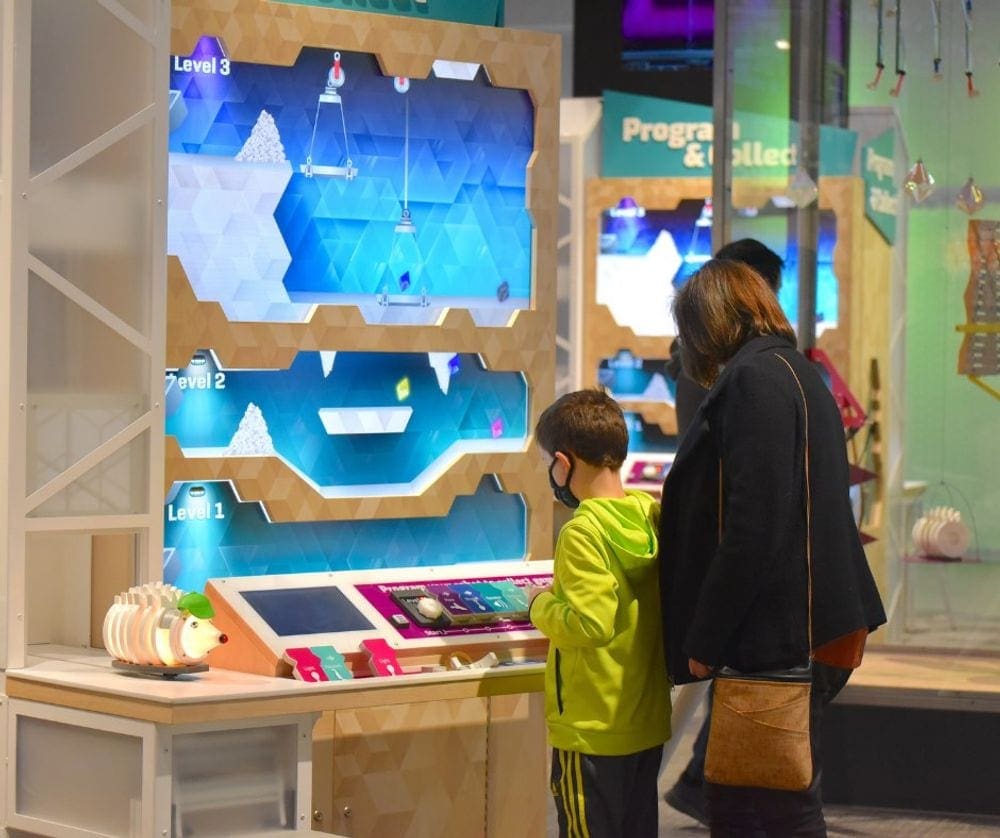 A mom and her young son look at an exhibit at the Museum of Science, Boston, one of the best things to do in Boston with kids.