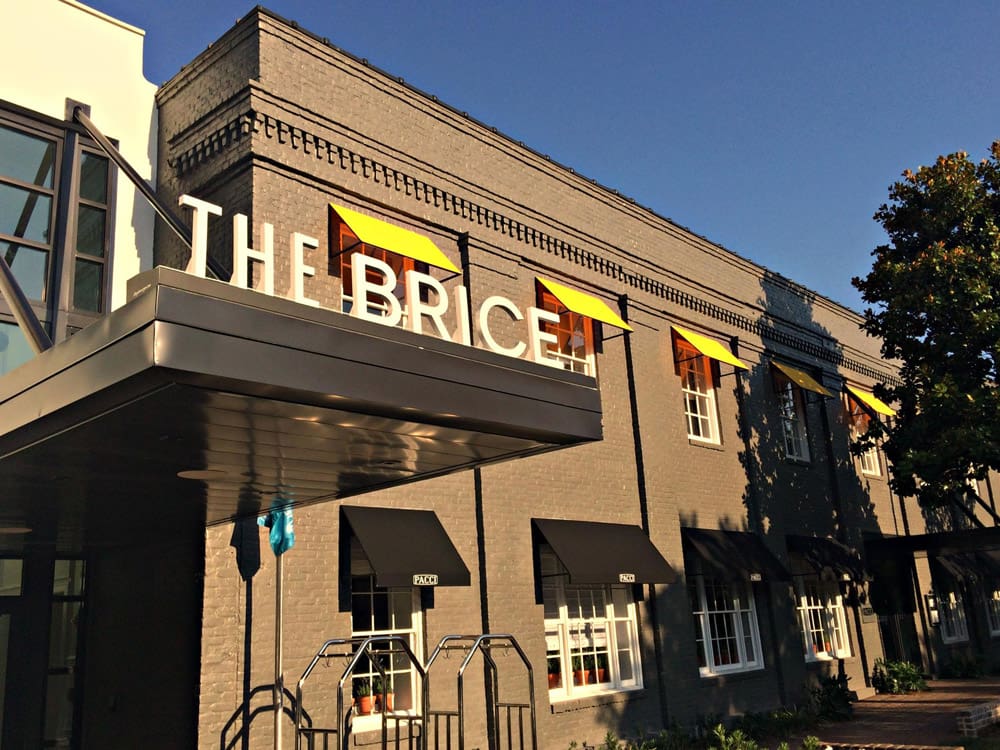 A close up of the entrance to the The Kimpton Brice Hotel on a bright sunny day, one of the best hotels in Savannah for families.